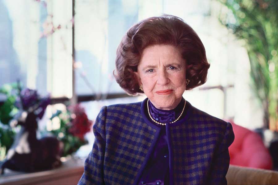 Portrait of LuEsther T. Mertz wearing a blue checkered suit.
