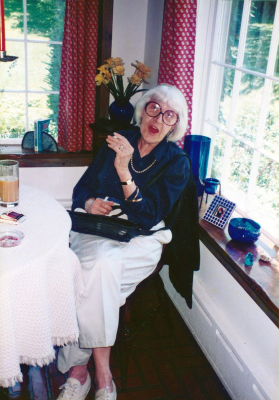 Helen Merrill sitting in the kitchen of good friend and client Christopher Durang.