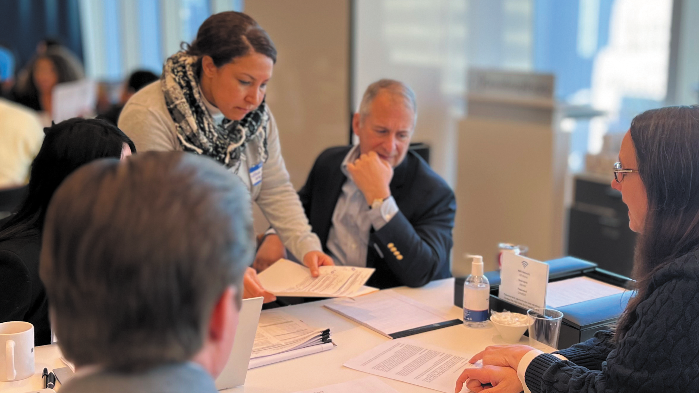 Attorneys photographed providing free legal help to recently arrived migrants as part of a Pro Se Plus Project.