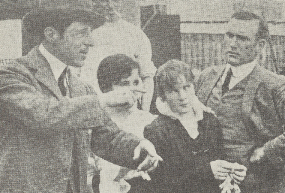 (Left to right) D. W. Griffith directs Teddy Lampson, Mae Marsh, and Donald Crisp.
