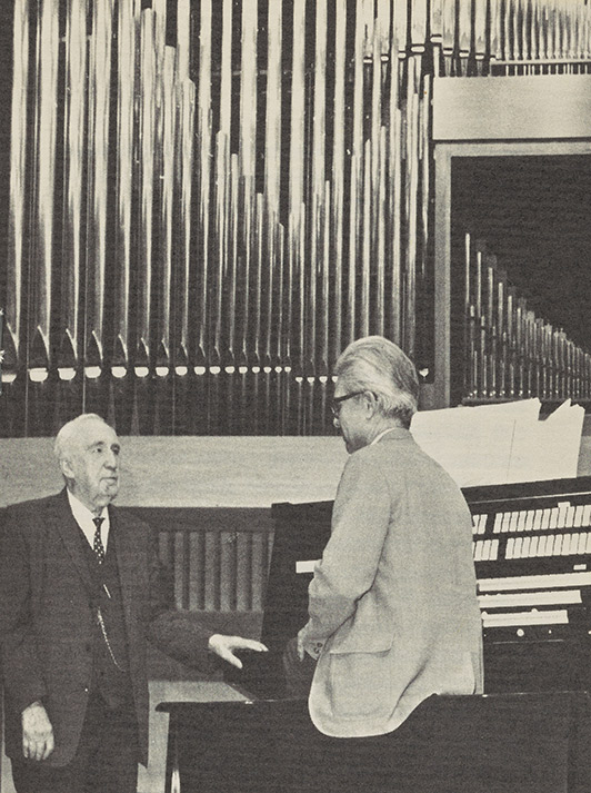 Dr. Walter B. Ford with Frank Eldridge, Professor of Music and Organist at Ithaca College, stand by the concert organ given by Dr. Ford to the School of Music.