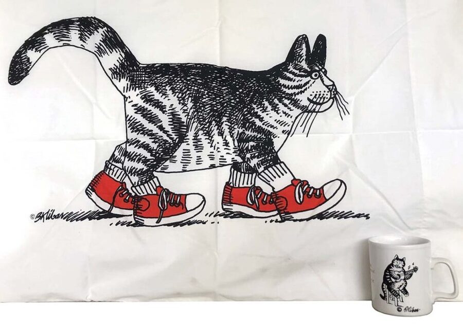 A black and white striped cat illustration walking with red shoes and white socks. A cup in the corner with a cat playing a stringed instrument. As president of Toni Mendez, Inc., she wore many hats, including licensor, merchandiser, syndicated feature representative, and literary agent.