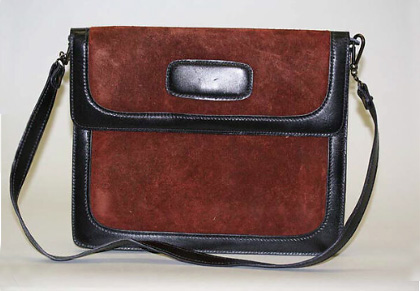 A Calderon shoulder bag in maroon with black straps.