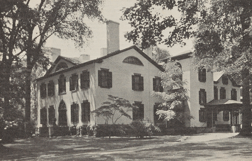 The Seward House Museum exterior surrounded by lush trees in Auburn, New York.