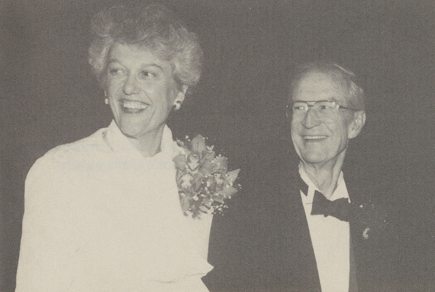 Maria (left) and Herbert West (right) at his retirement dinner, November 1989. Both are smiling. He is wearing a suit with a bowtie, and she is wearing a corsage.