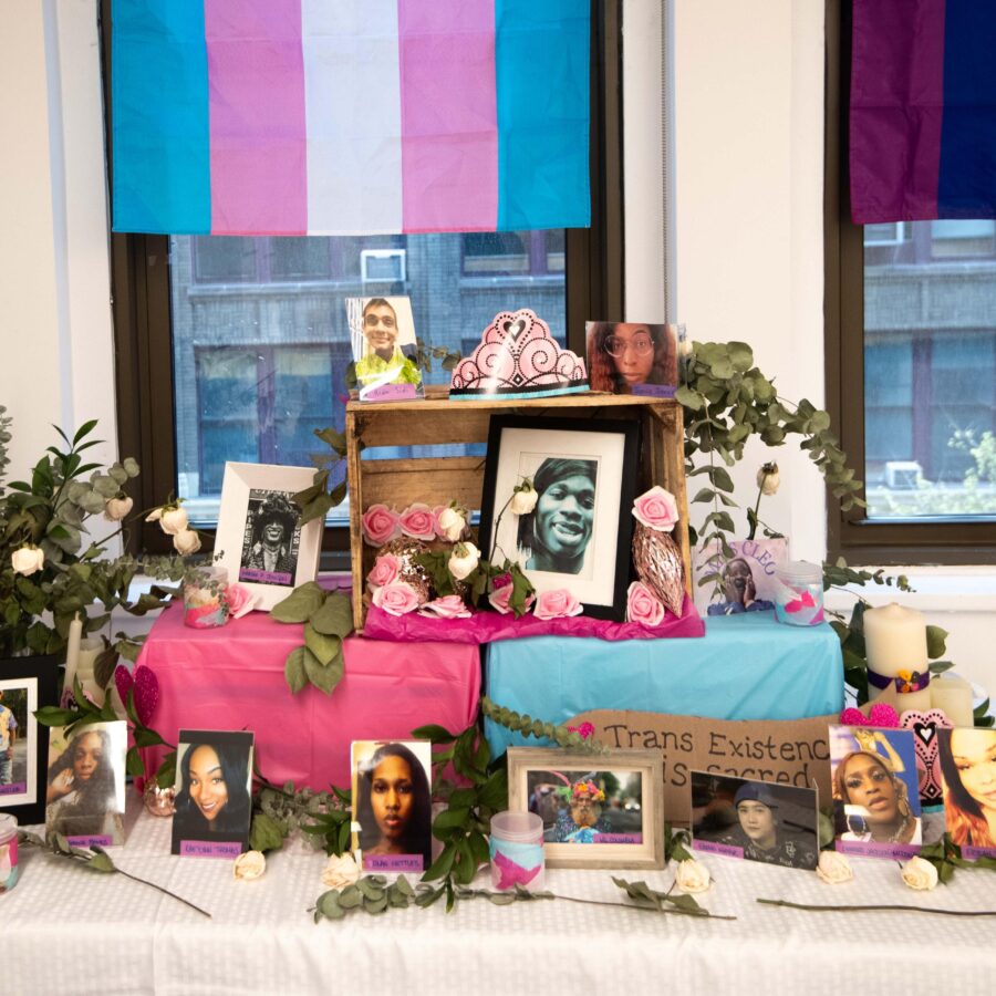 A commemoration of photos, candles, and flowers to honor Ali Forney and trans existence.