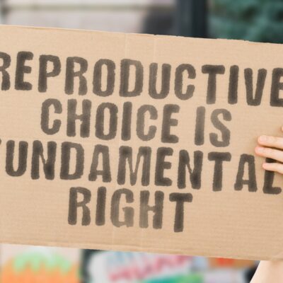 A person holds a sign that reads “Reproductive choice is a fundamental human right”