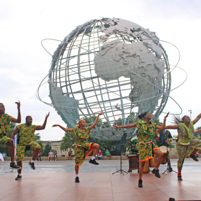 Dancers performing in front of the Unisphere in Flushing Meadows Corona Park.