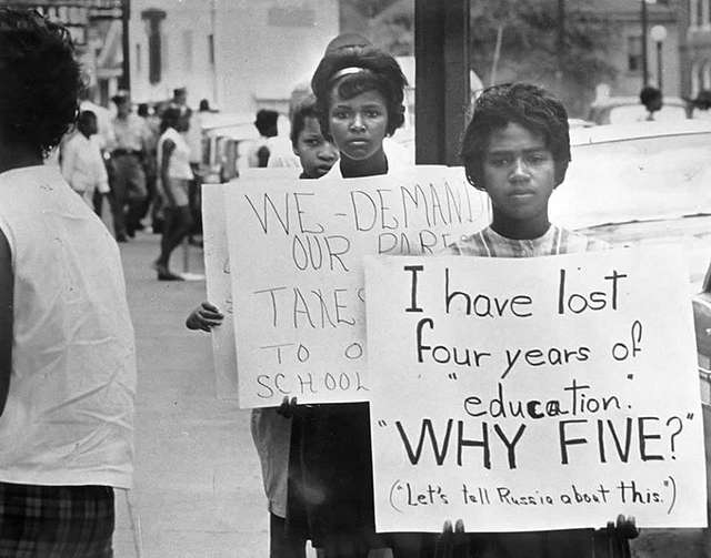 Students holding signs protesting school closures in Virginia following the 1954 Brown v. Board US Supreme Court decision.