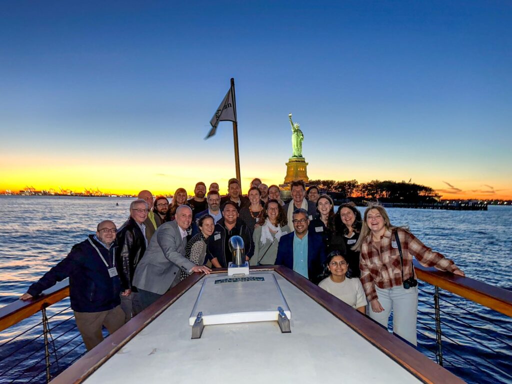 The Waterfront Alliance on a boat in the New York Harbor with the Statue of Liberty in the background.