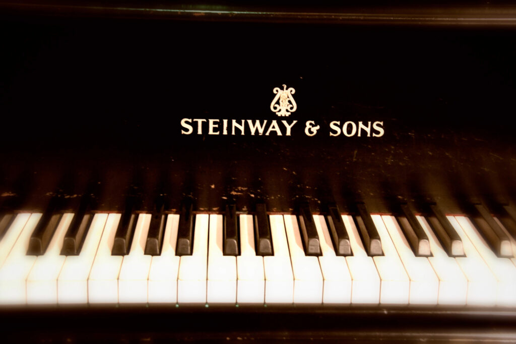 A classical piano that reads “Steinway & Sons” under its logo.