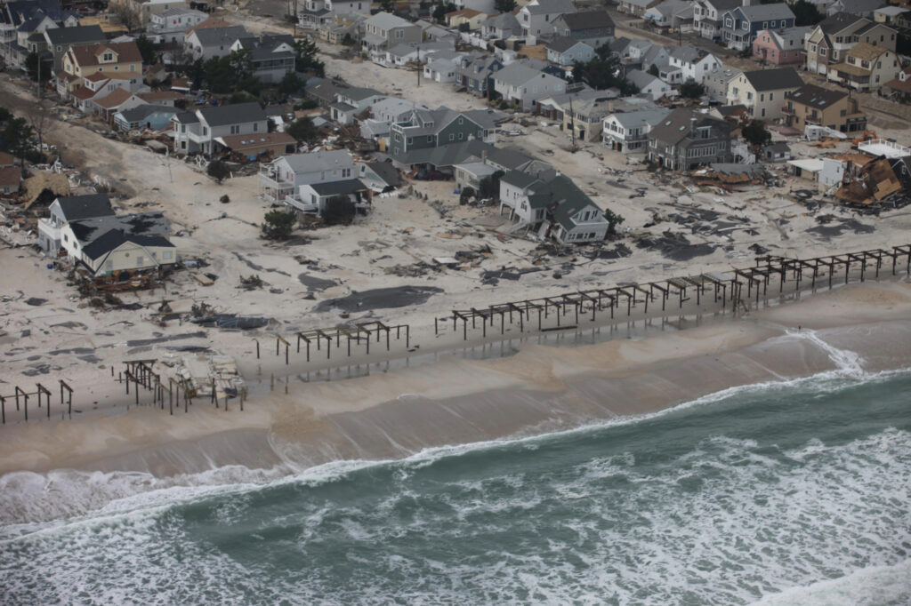 Aerial view of houses along the coast damaged after a storm surge.